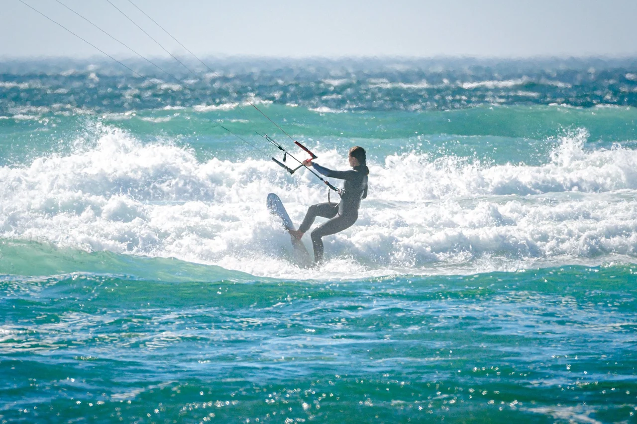 Kiteboarder riding a wave, from the practice’s original website